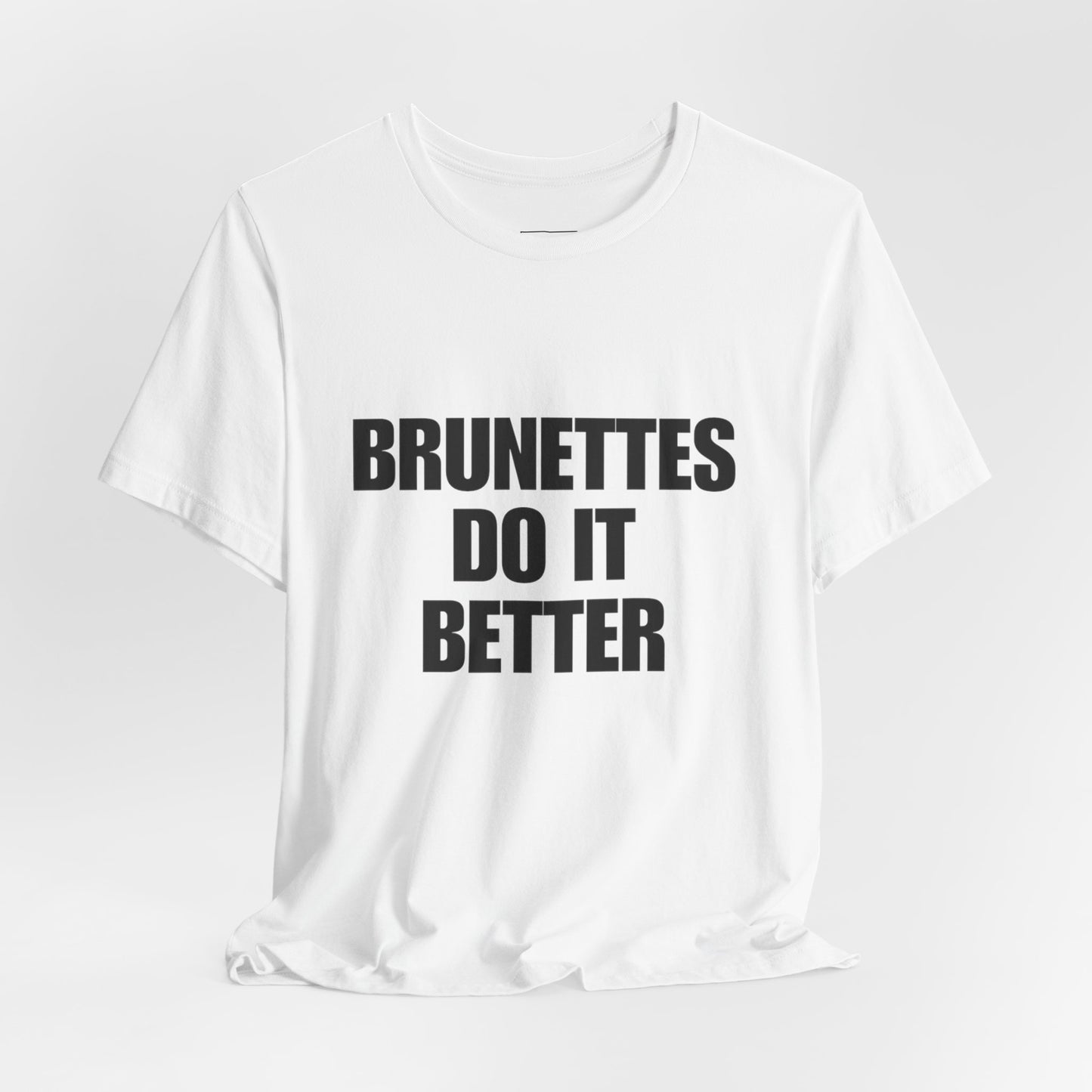 White t-shirt with 'BRUNETTES DO IT BETTER' text on a light gray background